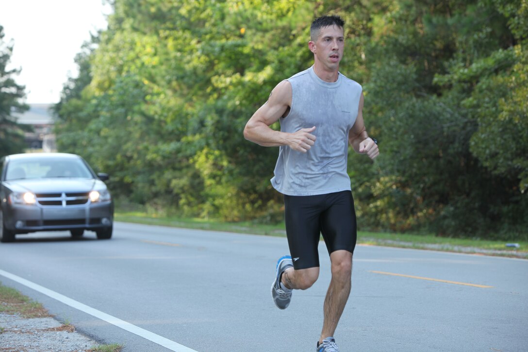 Maj. Joseph Jennings, judge advocate with Headquarters and Service Battalion, Marine Corps Base Camp Lejeune, makes his way to the Gottschalk Marina after completing a 1,000-meter swim in 16 minutes of the swim portion during the Commander's Cup Challenger series, aboard the base, July 29.