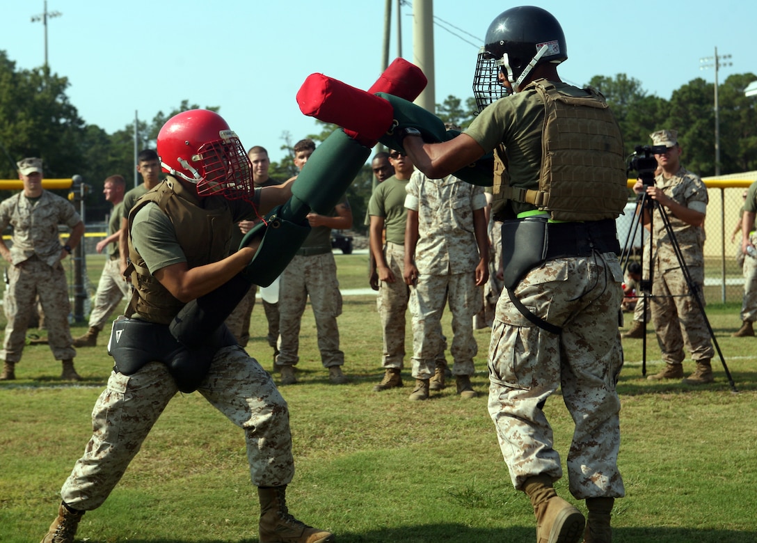 Two Marines in Headquarters Battalion, 2nd Marine Division, battle with pugil sticks during the Headquarters Battalion field meet aboard Marine Corps Base Camp Lejeune, N.C., July 29, 2011. The field meet was the closing to a year-long competition between the companies within the battalion.