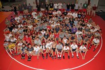 More than 120 high school athletes from Minnesota, Wisconsin, Iowa and the Dakotas pose with members of the All-Marine Wrestling Team and representatives from Recruiting Station Twin Cities after the last training session of the All-Marine Wrestling Camp July 29. Recruiting Station Twin Cities hosted the six-day camp to promote athletic and academic excellence. For additional imagery from the event, visit www.facebook.com/rstwincities.
