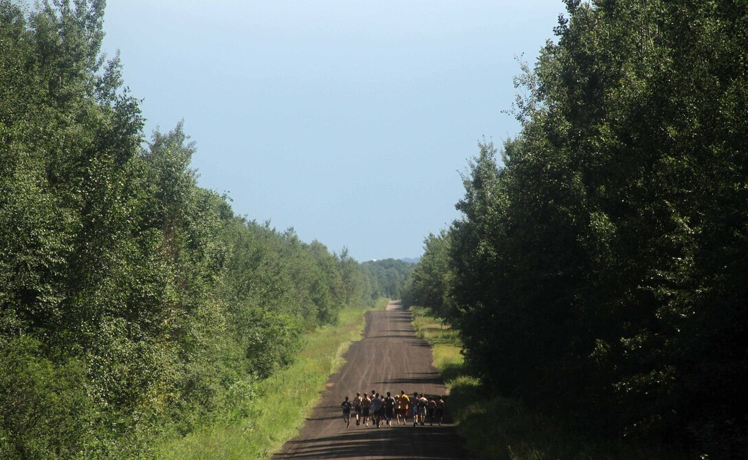 Wrestlers from Minnesota, Iowa, Wisconsin and the Dakotas begin a 3.5-mile obstacle course biathlon during the All-Marine Wrestling Camp July 29. The race started with a 20-event obstacle course then moved to a 3.5-mile run. Teams had to carry one full ammo can and water jug during the race, which ended with a simulated marksmanship exercise. The top team completed the biathlon in under 45 minutes. For additional imagery from the event, visit www.facebook.com/rstwincities.