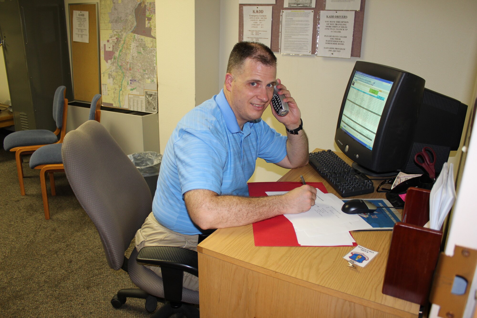 Master Sgt. Charles Small III, working as a dispatcher, takes location information from a caller in downtown Albuquerque.

Photo by Master Sgt. Candace Stacy
