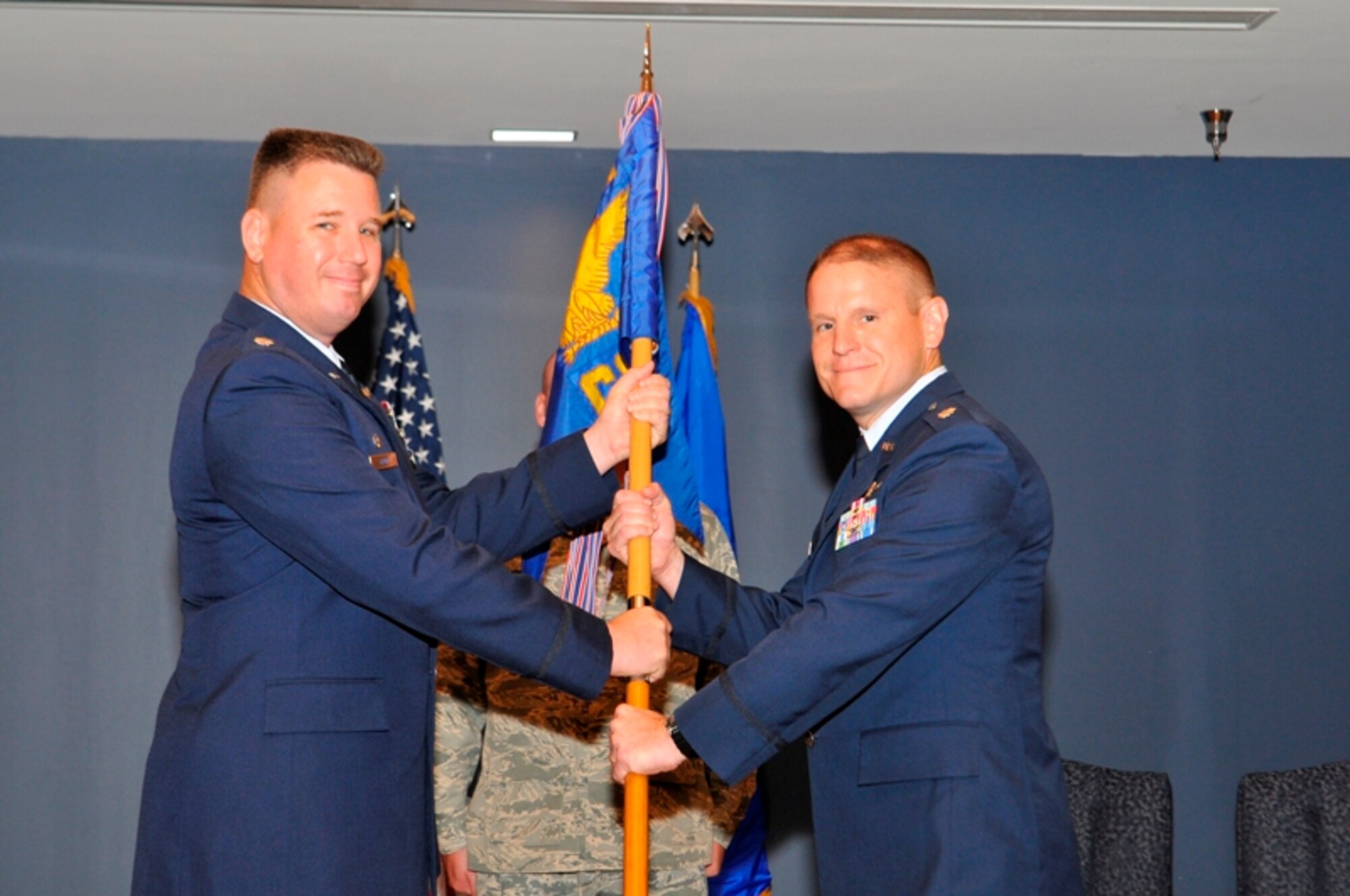 Lt. Col. William Grund, 325th Mission Support Group commander, passes command of the 325th Communications Squadron to Lt. Col. Wayne Wisneski during a change of command ceremony July 29. Colonel Wisneski replaces Lt. Col. Clorinda Trujillo, who departs Tyndall to serve in the force development cyber officer career field at the Pentagon in Washington, D.C. Colonel Wisneski arrives from Stuttgart Air Base, Germany, where he served as the 17th Air Force liaison officer to AFRICOM. (U.S. Air Force photo by Lisa Norman)