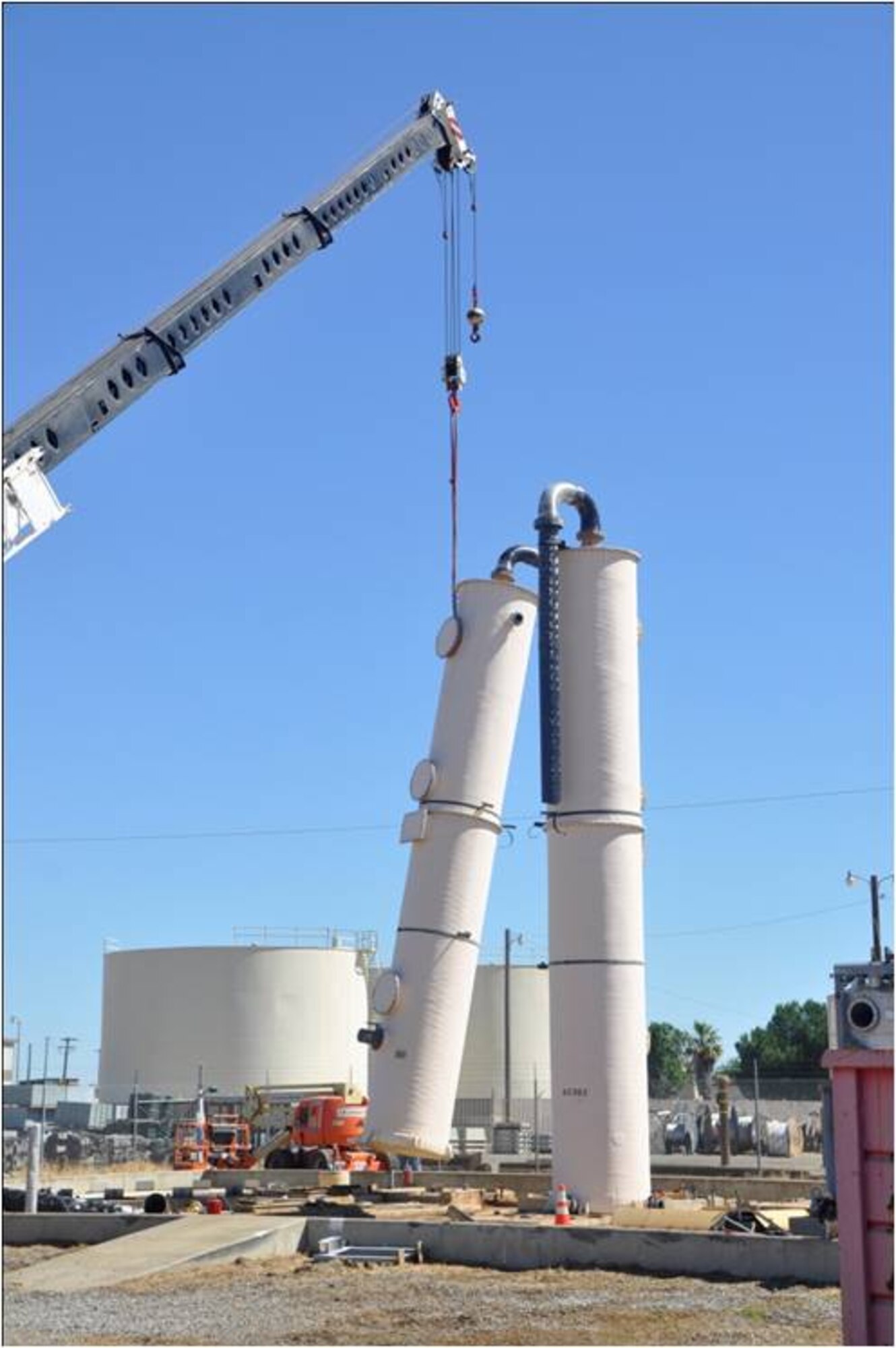 A crane  removes the first of two air stripper towers that were used to treat contaminated groundwater at the former  Castle Air Force Base in Atwater, Calif. The air stripping towers removed volatile organic compounds, primarily trichloroethene, a solvent used when the base was active.