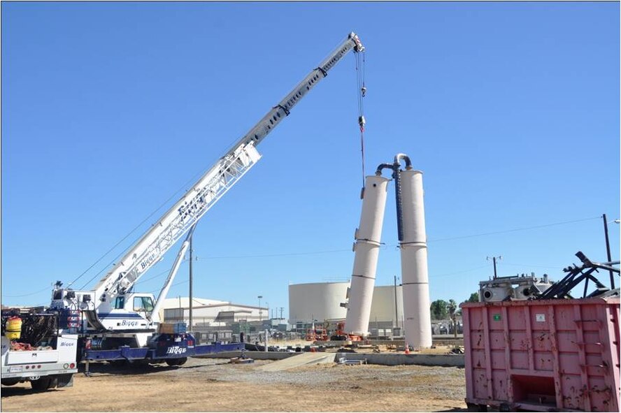 A crane  removes the first of two air stripper towers that were used to treat contaminated groundwater at the former  Castle Air Force Base in Atwater, Calif. The air stripping towers removed volatile organic compounds, primarily trichloroethene, a solvent used when the base was active.