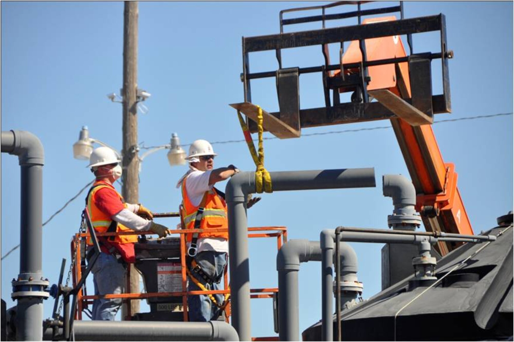 Construction workers removing pipes from one of the groundwater treatment systems at the former Castle Air Force Base in Atwater, Calif.  The Air Force has two additional groundwater treatment systems that continue to operate on the former base. This system had achieved its goal and is no longer needed for groundwater cleanup.