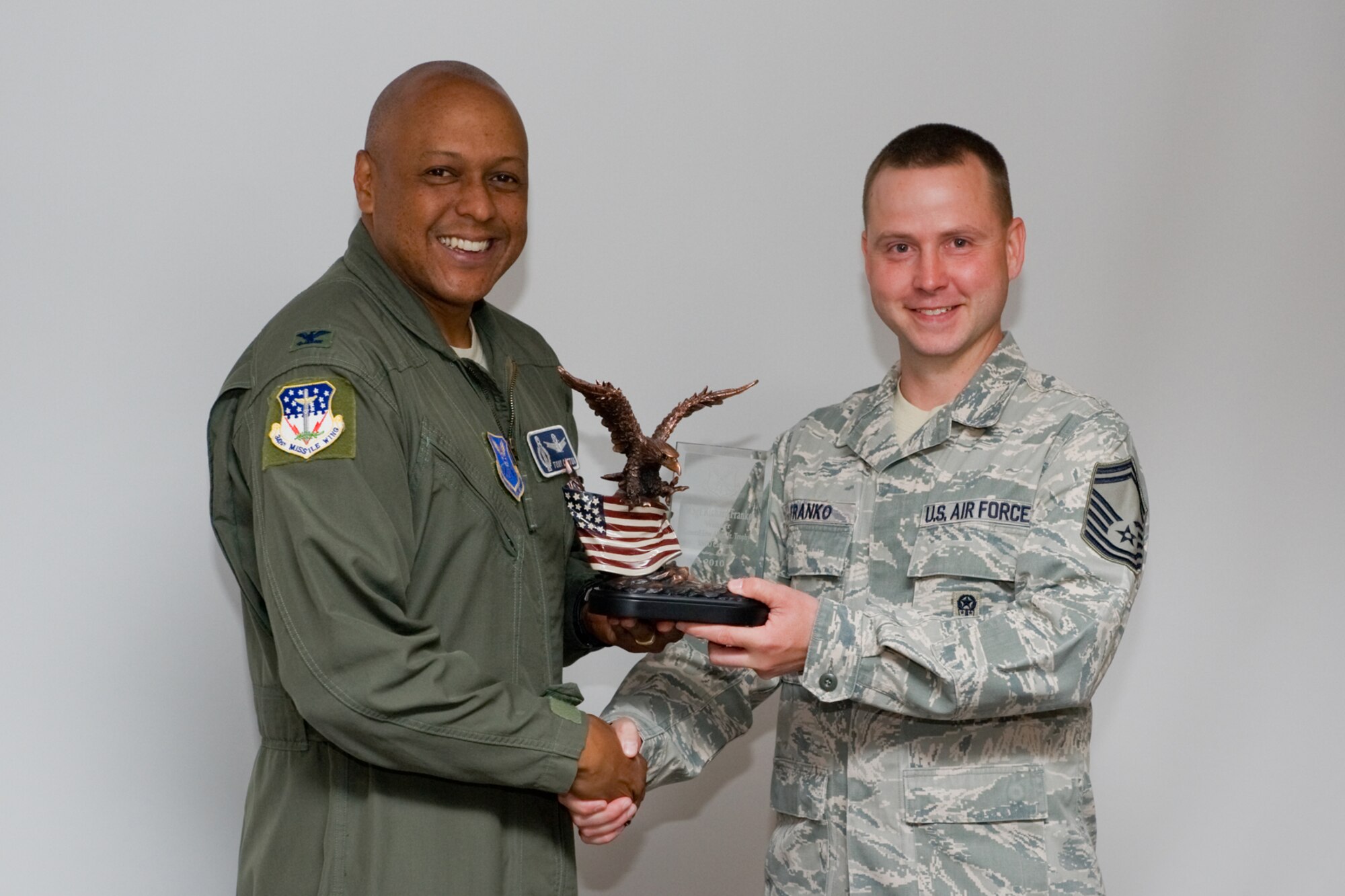 Col. Anthony Cotton, 341st Missile Wing commander, presents Senior Master Sgt. Richard Franko, 341st Maintenance Operations Squadron flight superintendent, with the Air Force Global Strike Command's 2010 General Lew Allen, Jr. trophy in the Senior NCO category July 20.  (U.S. Air Force photo/Beau Wade)