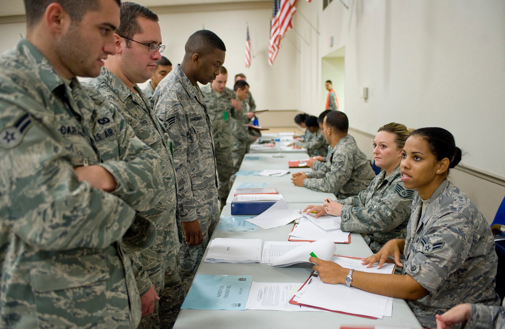 A group of simulated deployers process the deployment line during a mobility exercise on Barksdale Air Force Base, La., July 28. Before deploying, Airmen must make their way through a deployment line to ensure they have all of their affairs in order before they leave. (U.S. Air Force photo/Senior Airman Chad Warren) (RELEASED)