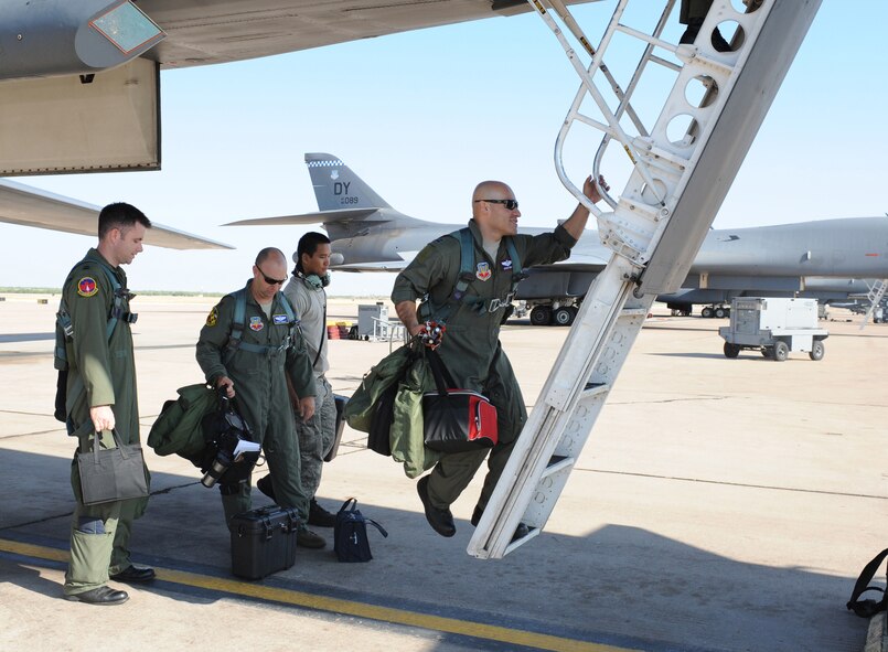 The 7th Operations Support Squadron Global Strike Challenge team boards a B-1 Bomber July 28, 2011, at Dyess AFB, Texas. The 7th OSS is one of five teams representing Dyess AFB as Dyess tries to bring home the championship a second year in a row.  (U.S. Air Force photo by Tech. Sgt. Darcie L. Ibidapo/Released)