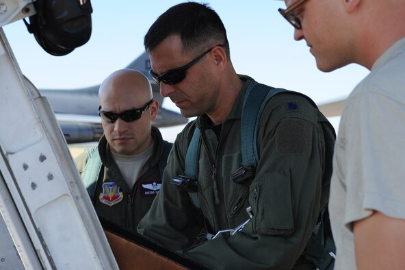U.S. Air Force Lt. Col. Devin Martin, 7th Operations Support Squadron, center, completes pre-flight inspection paperwork July 28, 2011, prior to the 7th OSS's Global Strike Challenge team take-off from Dyess AFB, Texas. The 7th OSS is one of five teams representing Dyess AFB as Dyess tries to bring home the championship a second year in a row.  (U.S. Air Force photo by Tech. Sgt. Darcie L. Ibidapo/Released)