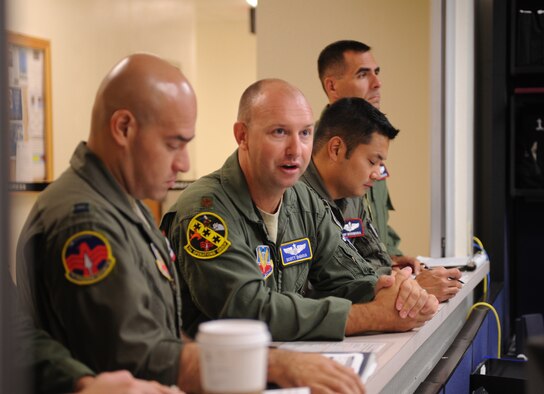 U.S. Air Force Maj. Scott DiGioia, 7th Operations Group, center, verifies pre-flight information July 28, 2011, with the 9th Bomb Squadron operations desk during the 7th Operations Support Squadron's Global Strike Challenge team pre-departure crew brief at Dyess AFB, Texas. The 7th OSS is one of five teams representing Dyess AFB as Dyess tries to bring home the championship a second year in a row.  (U.S. Air Force photo by Tech. Sgt. Darcie L. Ibidapo/Released)