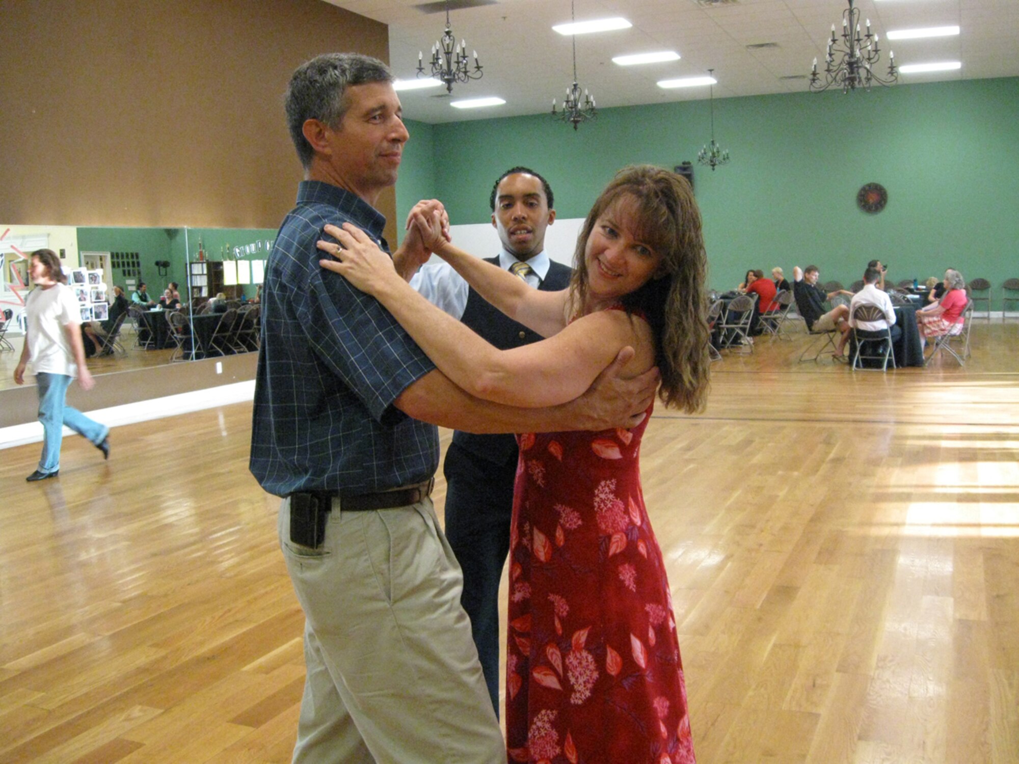 Vincent Ballard, a ballroom dance instructor with the National Dance Club in Murfreesboro, explains the proper dance hold and frame for the Waltz to Kirk and Tracy Rutland. (Photo provided)