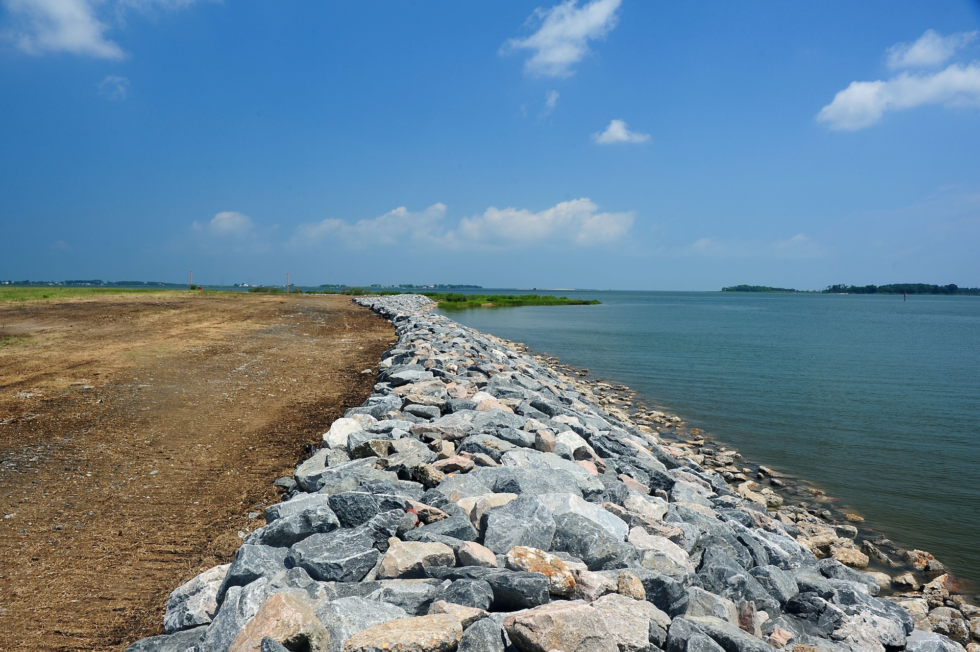 The granite rocks line the shoreline as part of a restoration project at Langley Air Force Base, Va., July 27, 2011. The 330 million year-old rocks are placed along Langley’s vulnerable waterside perimeter to strengthen and protect the shoreline around the base. (U.S. Air Force photo by Airman 1st Class Kayla Newman/Released)