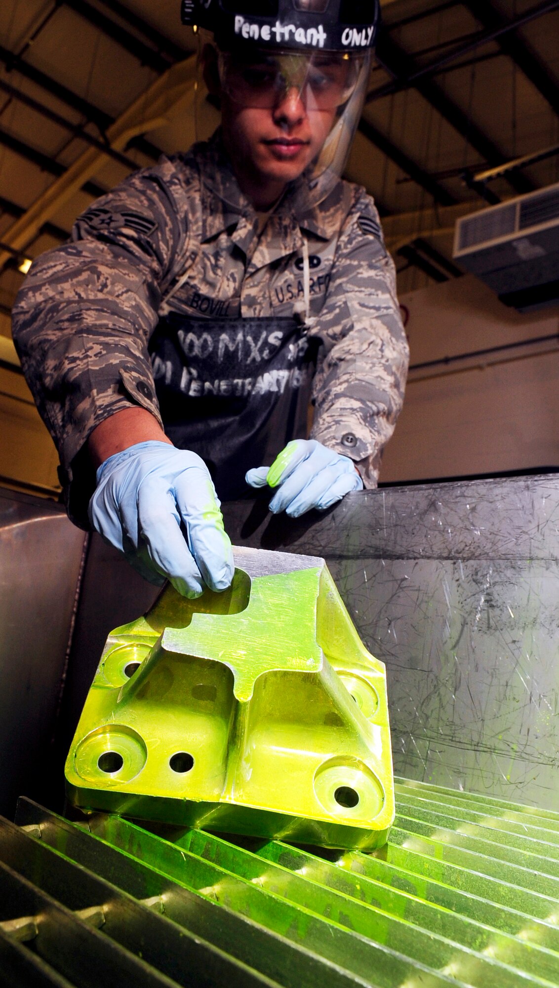 RAF MILDENHALL, England -- Senior Airman Christopher Bovill, 100th Maintenance Squadron Non-Destructive Inspection journeyman, lets excess fluorescent liquid penetrant drain from a KC-135 Stratotanker jack-mount during an inspection here July 28, 2011. Suspected damaged pieces of equipment are placed in the penetrant allowing it to be absorbed into any cracks that may be present. (U.S. Air Force photo/Senior Airman Ethan Morgan)