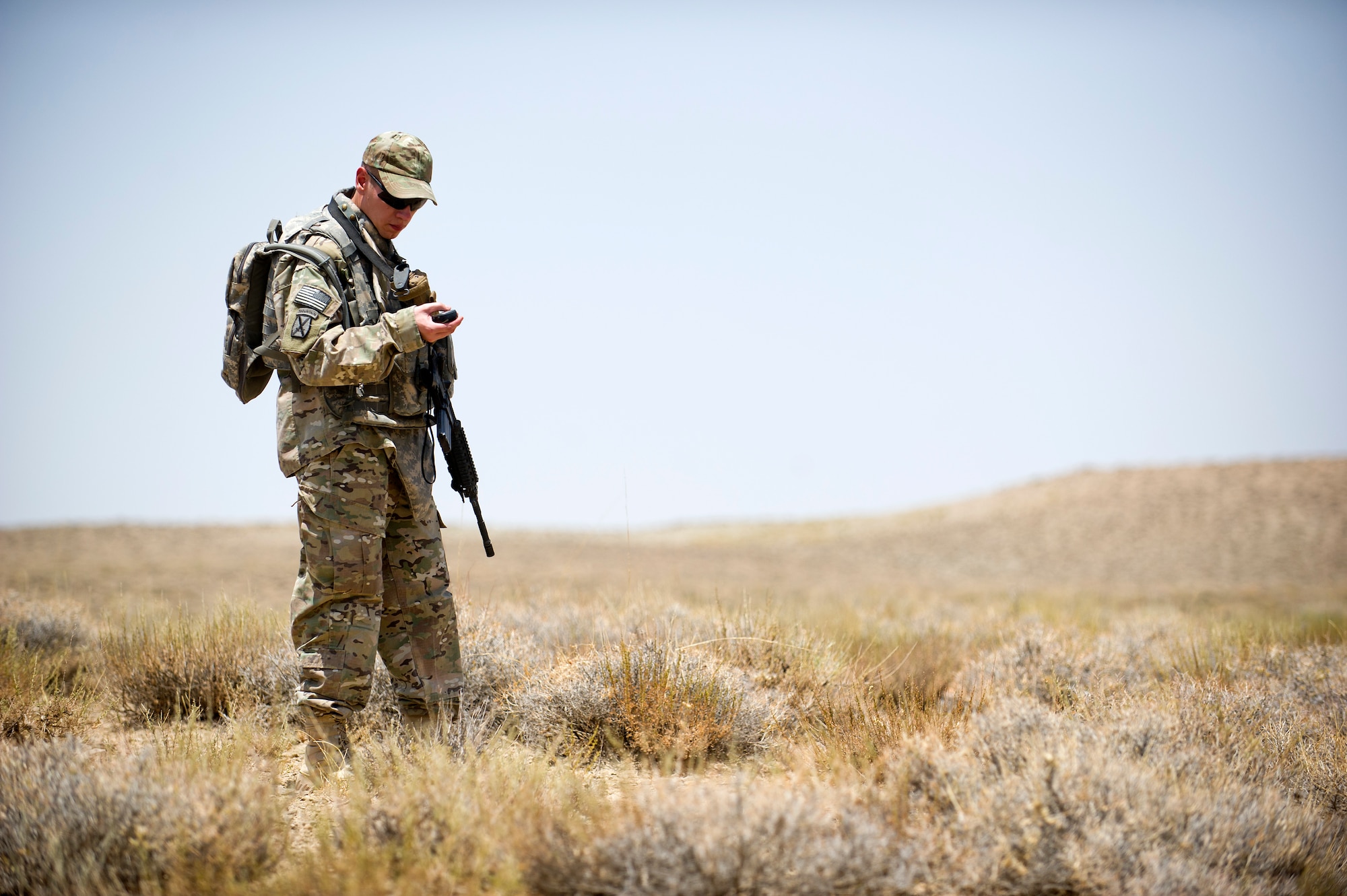 U.S. Air Force Capt. Matthew Zahler, air mobility liaison officer, checks the Global Positioning System coordinates for the center of a drop zone he is surveying near an Afghanistan border police outpost in southern Afghanistan. The first area surveyed couldn't be used because it is in an area the Taliban use to attack the border police. (U.S. Air Force Photo/Master Sgt. Jeffrey Allen)