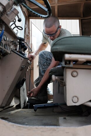 Senior Airman Bruce Christensen checks the oil level of an M-series wrecker at the Transit Center at Manas, Kyrgyzstan, July 26. Once this wrecker is operational, it will be used to dislodge stuck vehicles and haul disabled vehicles to the maintenance yard for repairs. Christensen is a 376th Expeditionary Logistics Readiness Squadron special purpose mechanic craftsman deployed here from the Utah Air National Guard. (U.S. Air Force photo/Tech. Sgt. Tammie Moore)