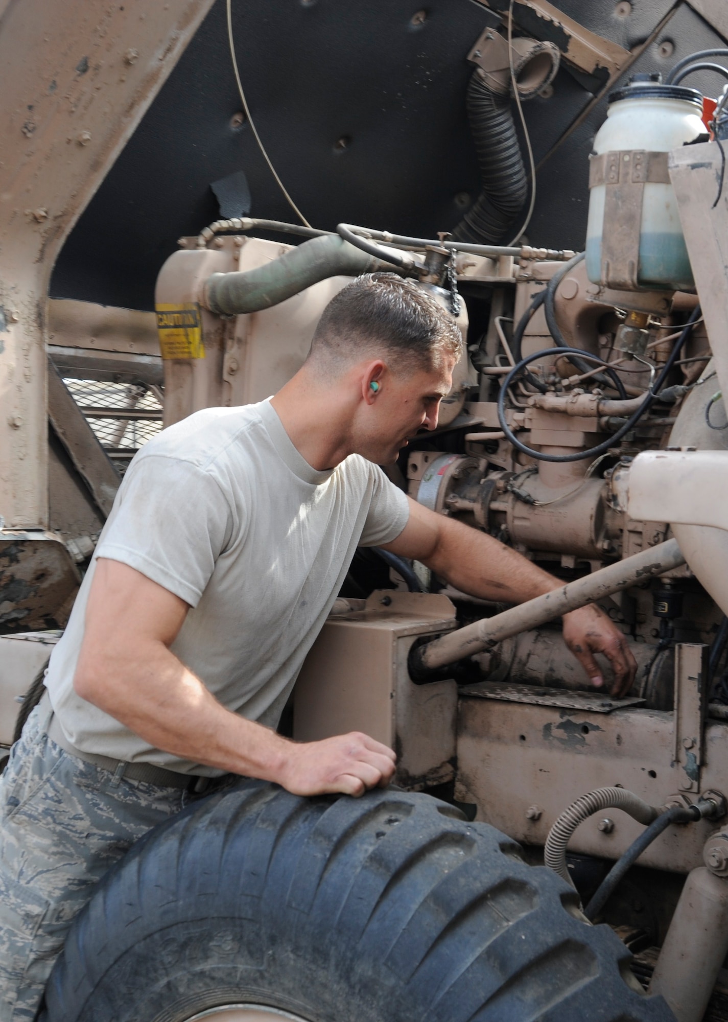 Tech. Sgt. Adam Heath examines a high-pressure oil line while working on an M-series wrecker at the Transit Center at Manas, Kyrgyzstan, July 26. Heath has spent two months overhauling the Transit Center’s only wrecker. He’s a 376th Expeditionary Logistics Readiness Squadron vehicle maintenance journeyman deployed here from the Utah Air National Guard. (U.S. Air Force photo/Tech. Sgt. Tammie Moore)