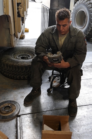 Staff Sgt. Jeffrey Kukuk inspects a brake caliper at the Transit Center at Manas, Kyrgyzstan, July 26. Kukuk is a 376th Expeditionary Logistics Readiness Squadron fire truck maintainer deployed here from Dover Air Force Base, Del. (U.S. Air Force photo/Tech. Sgt. Tammie Moore)