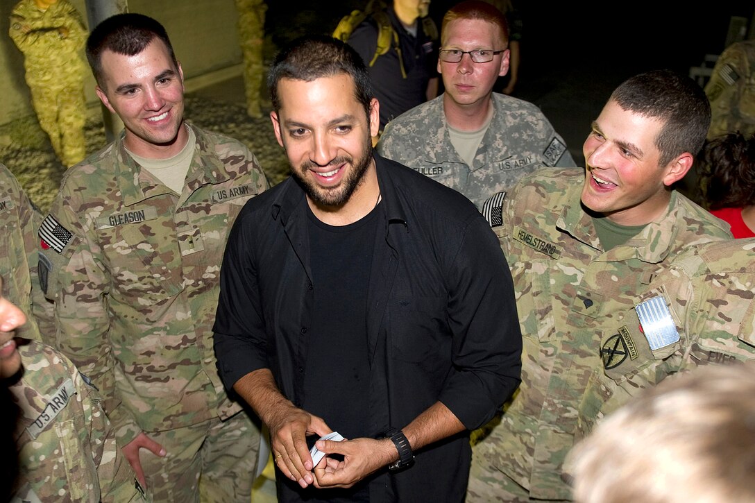 Magician David Blaine entertains troops during a visit to Kandahar Air Field in Afghanistan, July 28, 2011.