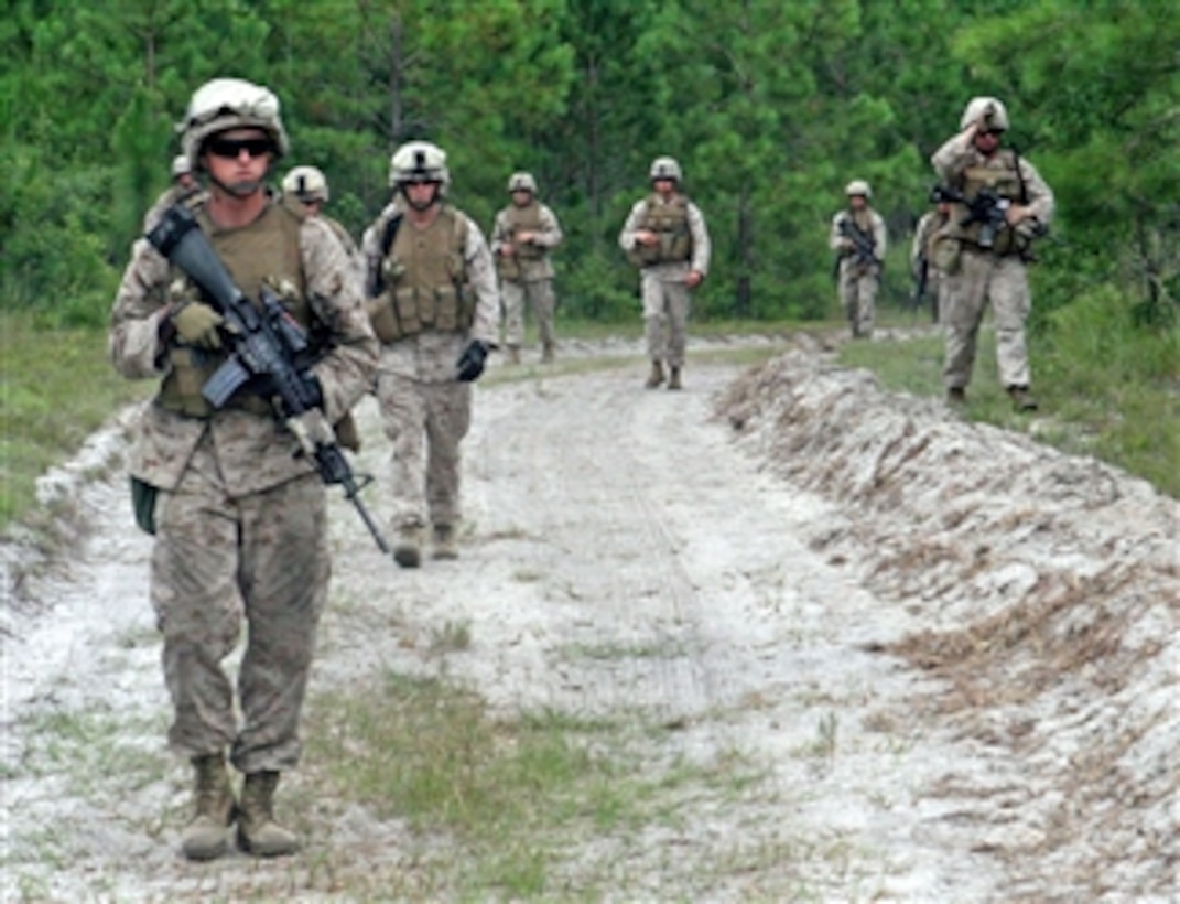 Marines with 1st Battalion, 2nd Marine Regiment, 2nd Marine Division, perform squad attacks and live fire exercises as part of their training for future deployments aboard Marine Corps Base Camp Lejeune, N.C., on July 26, 2011.  The squads each went on simulated patrols till they reached their objective points.  