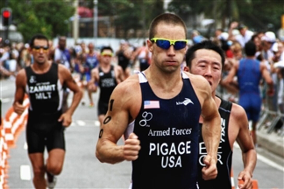 U.S. Coast Guard Petty Officer 2nd Class Bradley Pigage, competitor number 100, races in the triathlon event at the 5th International Military Sports Council World Games in Rio de Janeiro, Brazil, on July 24, 2011.  