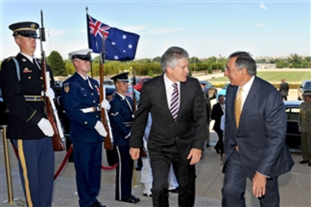 Secretary of Defense Leon E. Panetta (right) escorts Australian Minister of Defense Stephen Smith through an honor cordon and into the Pentagon on July 27, 2011.  Panetta and Smith will hold security talks on a variety of issues.  