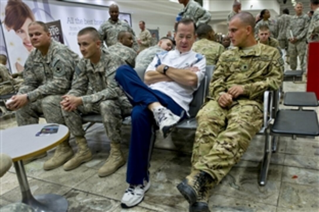 U.S. Navy Adm. Mike Mullen, chairman of the Joint Chiefs of Staff, visits with U.S. soldiers during a stop at Shannon Airport, Ireland, July 28, 2011. Mullen is on a five-day USO tour with comedian Jon Stewart, NBA legend Karl Malone and magician David Blaine to visit troops in Afghanistan and Iraq. 