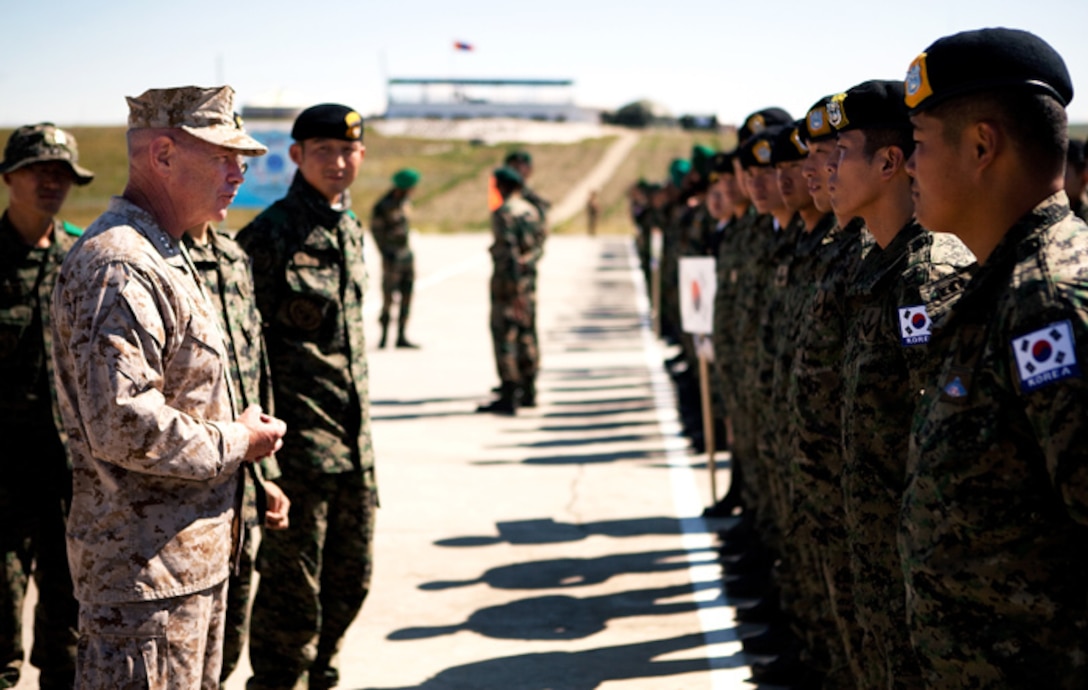 Lt. Gen. Kenneth J. Glueck Jr., commanding general, III Marine Expeditionary Force, greets Republic of Korea special forces service members from the Korea’s 21st Battalion, International Peace Keeping Force, before the opening ceremony of Exercise Khaan Quest 2011 at Five Hills Training Area, Ulaanbaatar, Mongolia, July 31. Khaan Quest is a training exercise designed to strengthen the capabilities of U.S., Mongolian and other nations' forces in international peace support operations worldwide.
