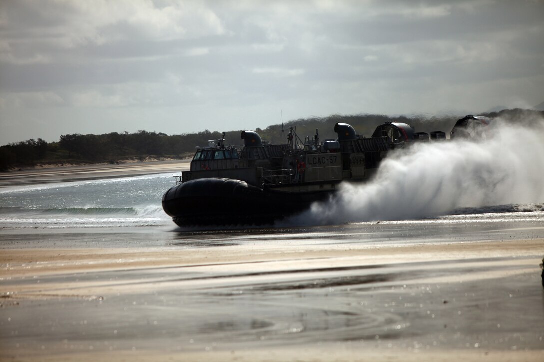 A U.S. Navy landing craft air cushioned comes ashore to load vehicles, equipment, and personnel of the 31st Marine Expeditionary Unit, July 30. The LCAC was transporting equipment, vehicles and personnel to USS Germantown (LSD 42) after the successful completion of exercise Talisman Sabre 2011.  TS11 is the largest joint military exercise undertaken by the Australian Defence Force. Around 14,000 U.S. and 9,000 Australian personnel have participated. TS11 provided an opportunity to conduct operations in a combined and joint environment that increased both countries’ bilateral war-fighting capabilities to respond to crisis and to provide humanitarian assistance. The 31st MEU is the only continuously forward-deployed MEU and remains the nation’s force in readiness in the Asia-Pacific region.