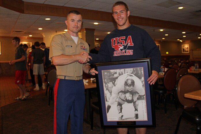 Recruiting Station Twin Cities Commanding Officer Maj. Kenneth Gawronski presents Richard Carlson with the Forrest M. Peterson MVP Award during the All-Marine Wrestling Camp awards ceremony July 30. Camp coordinators named Carlson, an Arden Hills, Minn., native, the MVP out of 120 athletes from Minnesota, Wisconsin, Iowa and the Dakotas attending the six-day wrestling clinic. For additional imagery and stories about the All-Marine Wrestling Camp, visit www.facebook.com/rstwincities.