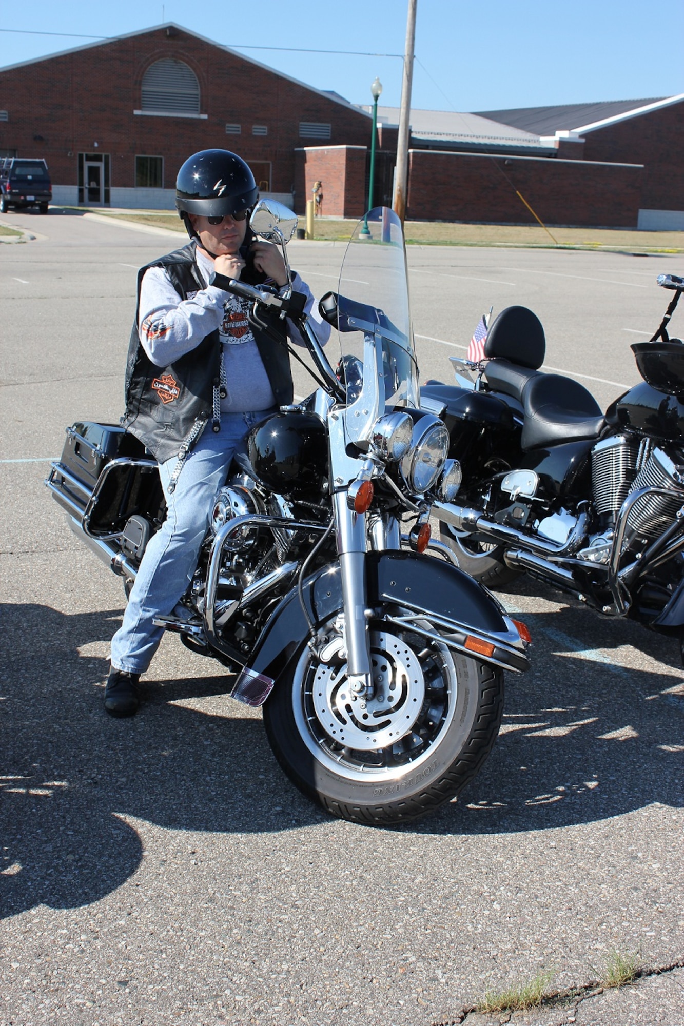 SSgt. Steven Bilof, security policeman with the 127th Security Forces Squadron, prepares to participate in the first Motorcycle Mentorship Poker Run on July 30 from Selfridge Air National Guard Base.  Personal protective equipment required to ride on Selfridge includes sturdy shoes, long pants, long sleeves, gloves, and eye protection, as well as a helmet.  The motorcycle rally focused on rider mentorship and safety.(USAF photo by Capt. Penny Carroll)