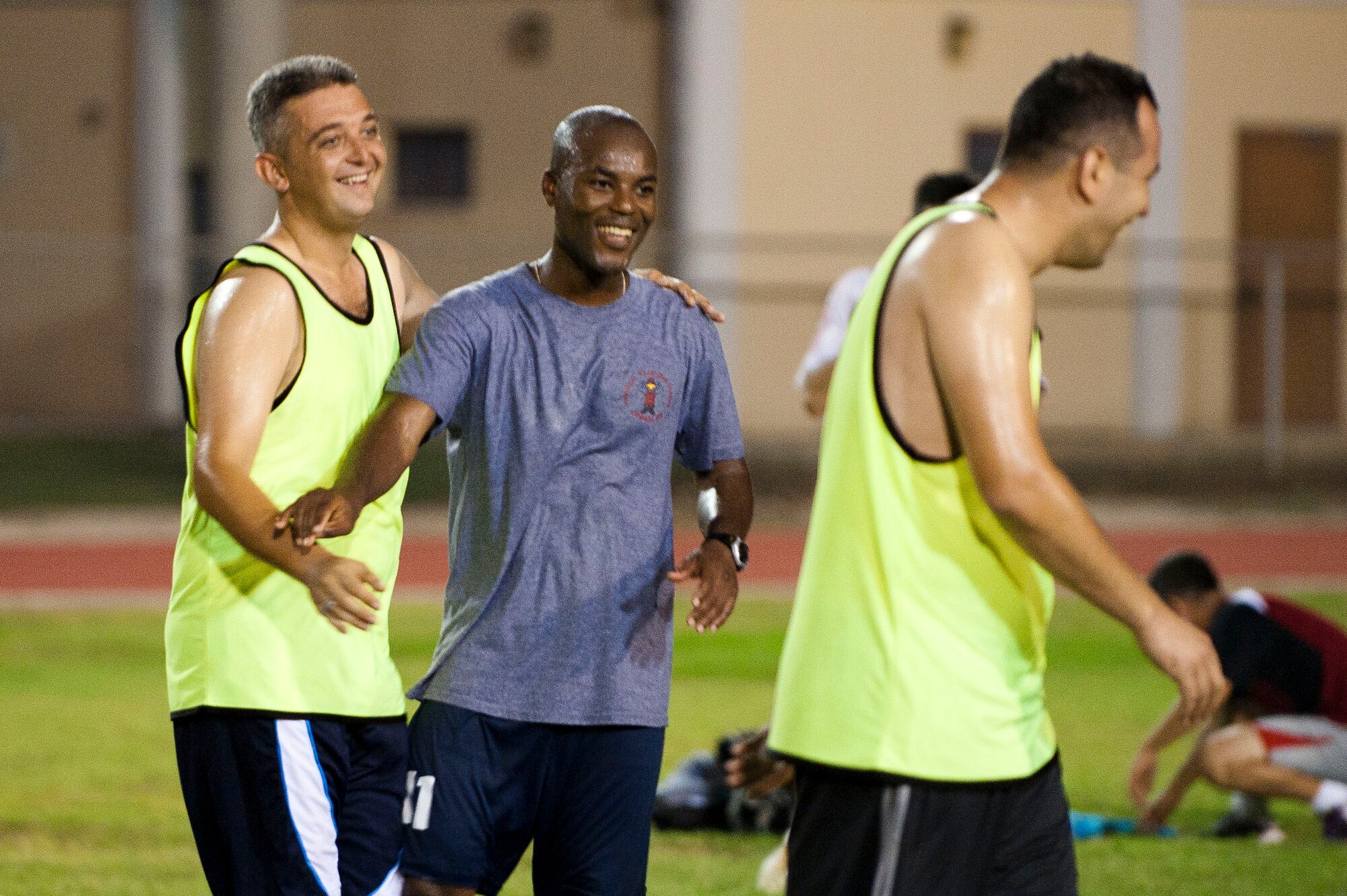 Aziz Tetou, center, 39th Contracting Squadron, is congratulated by Turkish air force Hakan Yildez after scoring a goal during the Late Night Soccer Tournament July 29, 2011, at Incirlik Air Base, Turkey. Eleven U.S. and Turkish Air Force teams competed in the double-elimination tournament. (U.S. Air Force photo by Airman 1st Class Clayton Lenhardt/Released)