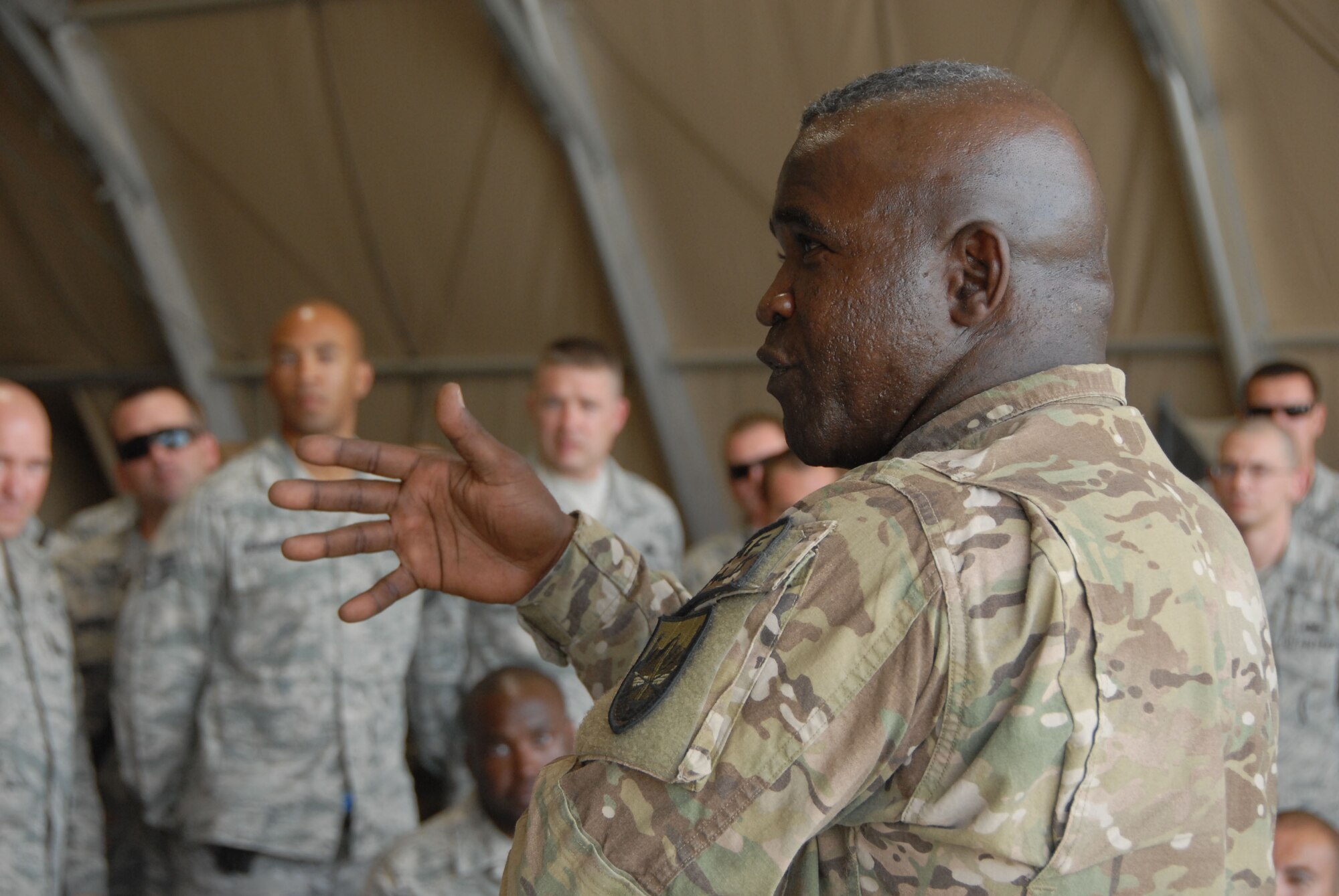 Command Sergeant Major Marvin Hill, senior enlisted U.S. military member in Afghanistan, addresses a crowd of aircraft mechanics at Kandahar Airfield, Afghanistan on July 20. Hill was collecting feedback from the maintainers on behalf of Gen. John Allen, who recently replaced Gen. David Petraeus as ISAF commander. (U.S. Air Force photo by Tech. Sgt. Emily F. Alley)