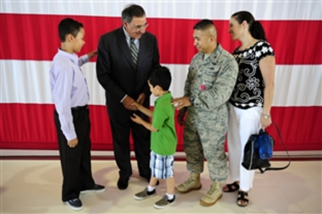 Defense Secretary Leon E. Panetta meets the family of Air Force Maj. Floyd Melchor after presenting him with a Bronze Star medal during a ceremony at Peterson Air Force Base, Colo., July 29, 2011.