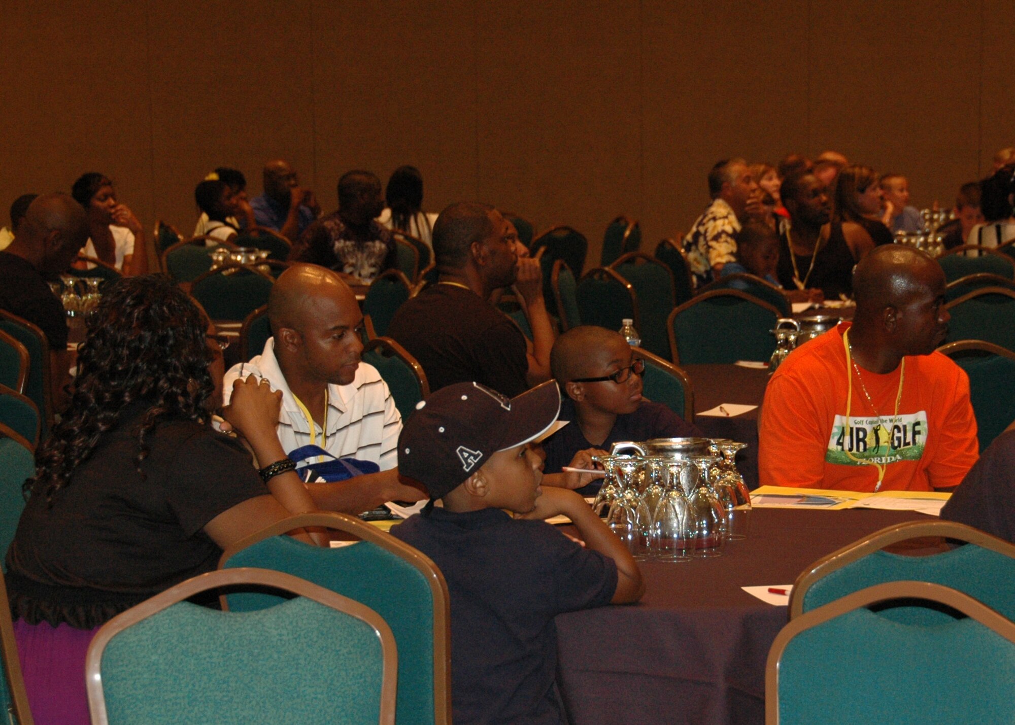 Air Force reservists and their family members listen during opening ceremonies July 23 at the Yellow Ribbon Program’s Southeast Region event held at a hotel in Ponte Vedra, Fla., July 23-24.  The YRP is a Department of Defense initiative offering a wide range of specialized support and information to military members and families of the Air Force Reserve and National Guard to help them cope with the unique stresses of military deployments.  The recent YRP event brought together attendees from Duke Field and several other Southeast region military installations. (U.S. Air Force photo/Maj. Terry Lisenbee)