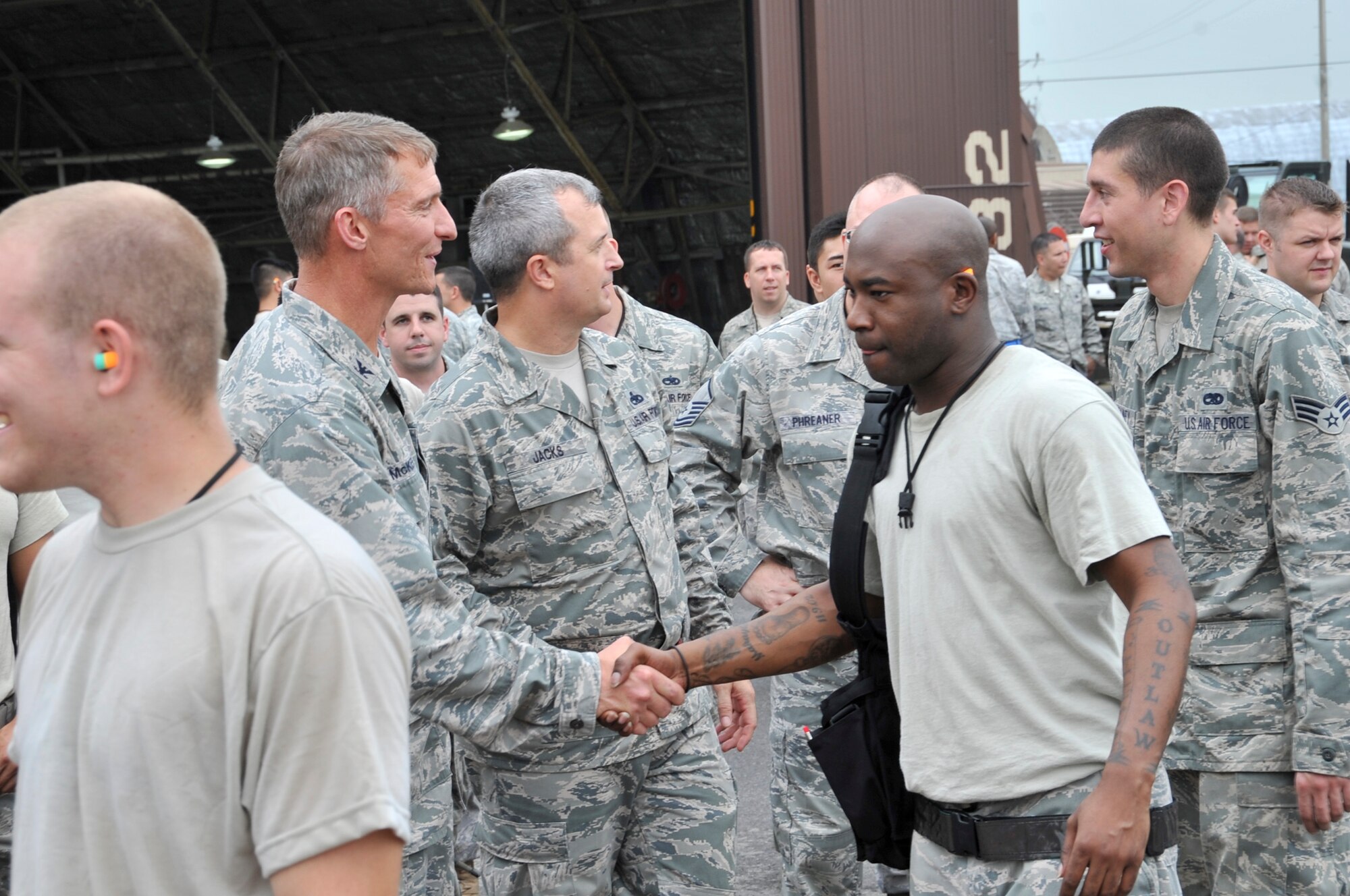 Team members from the 25th, 36th and 354th Aircraft Maintenance Unit; shake the hands of Col. Patrick T. McKenzie, 51 Fighter Wing commander after competing in the 51 Fighter Wing load crew competition   July. 22. The competition also boosted esprit de corps and morale for all team members and crews who participated. (U.S. Air Force Photos by/ Senior Airman Adam Grant)