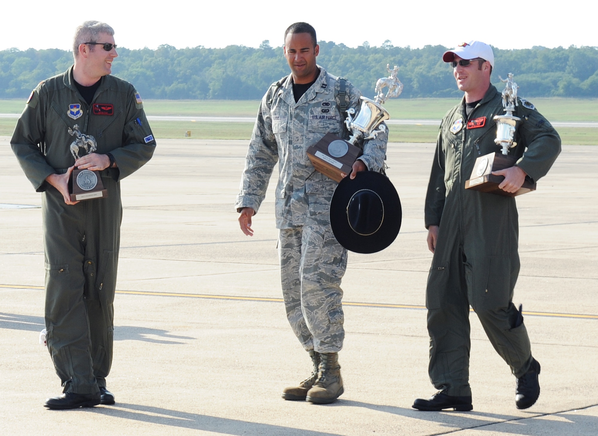 Maj. John Fay, a 314th Operations Group navigator; Capt. Jason Lugo, 314th Aircraft Maintenance Squadron aircraft maintenance unit officer-in-charge; and Maj. J.P. Kilker, 314th Airlift Wing Legacy C-130 team chief, hold trophies on July 30, 2011, at Little Rock Air Force Base, Ark. The 314th Airlift Wing brought back six trophies from the Air Mobility RODEO competition at McChord Field at Joint Base Lewis-McChord, Wash.  (U.S. Air Force photo by Airman 1st Class Ellora Remington)