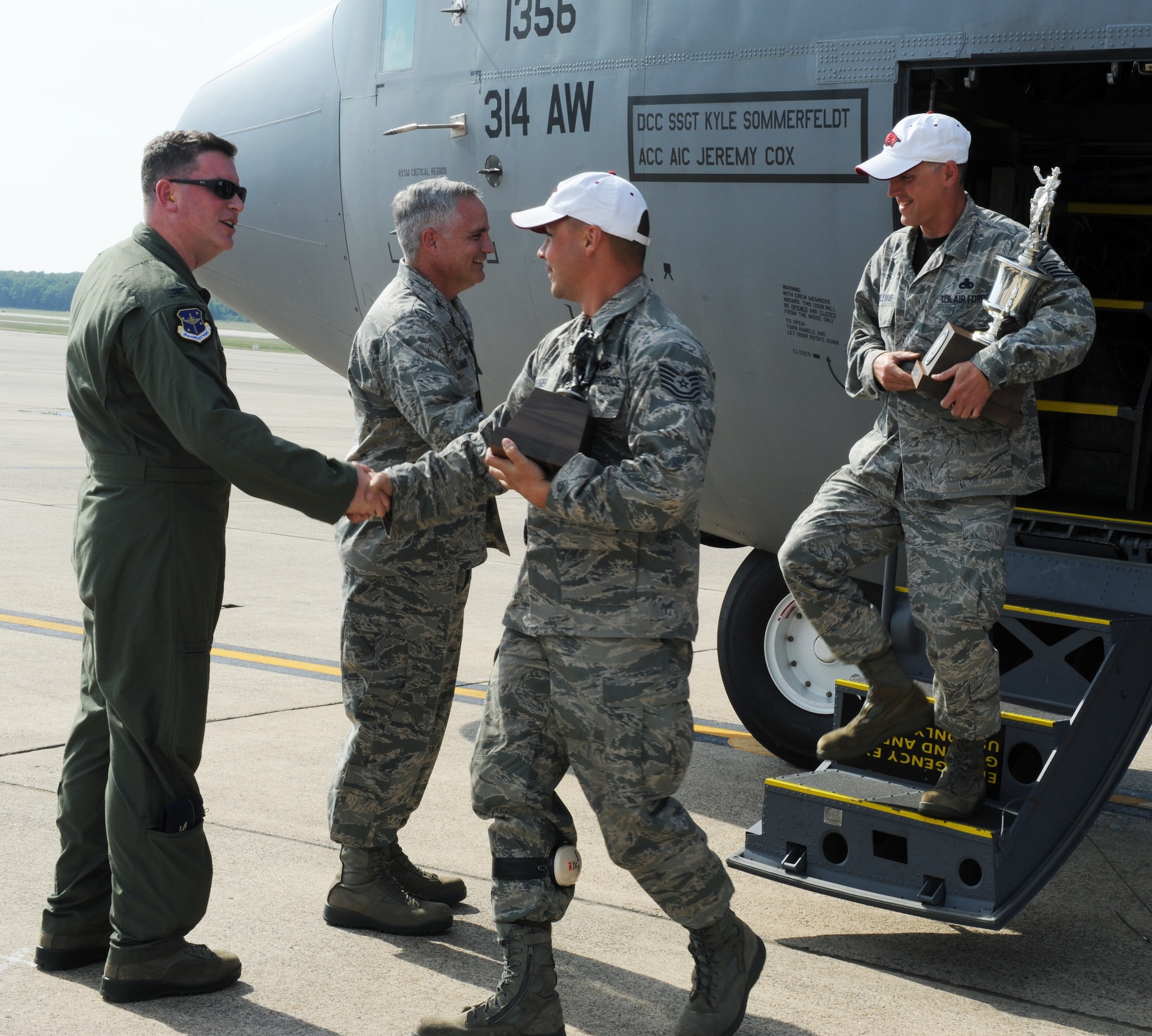 Col. Thomas Crimmins, 19th Airlift Wing vice commander, greets Tech. Sgt. Roger Geiger, a 314th Aircraft Maintenance Squadron C-130J craftsman, on the flightline July 30, 2011, at Little Rock Air Force Base, Ark. The 314th Airlift Wing brought back six trophies from the Air Mobility RODEO competition at McChord Field at Joint Base Lewis-McChord, Wash.  (U.S. Air Force photo by Airman 1st Class Ellora Remington)