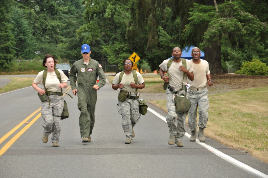 Lt. Col. Brad Hamby, Farchild Rodeo team chief, second from left, and Chief Master Sgt. Kevin Puryear, Air National Guard Readiness Center, Joint Base Andrews, Md., far right, run the end of the challenge course with 92nd Comptroller Squadron members, from left, Staff Sgt. Christie Bates, Senior Airman Lyndell Bowie and Tech. Sgt. Adrienne Johnson July 26. This challenge was part of the finance competition at Air Mobility Rodeo, Joint Base Lewis-McChord, Wash. (U.S. Air Force Photo/Tech. Sgt. Jennifer Buzanowski)