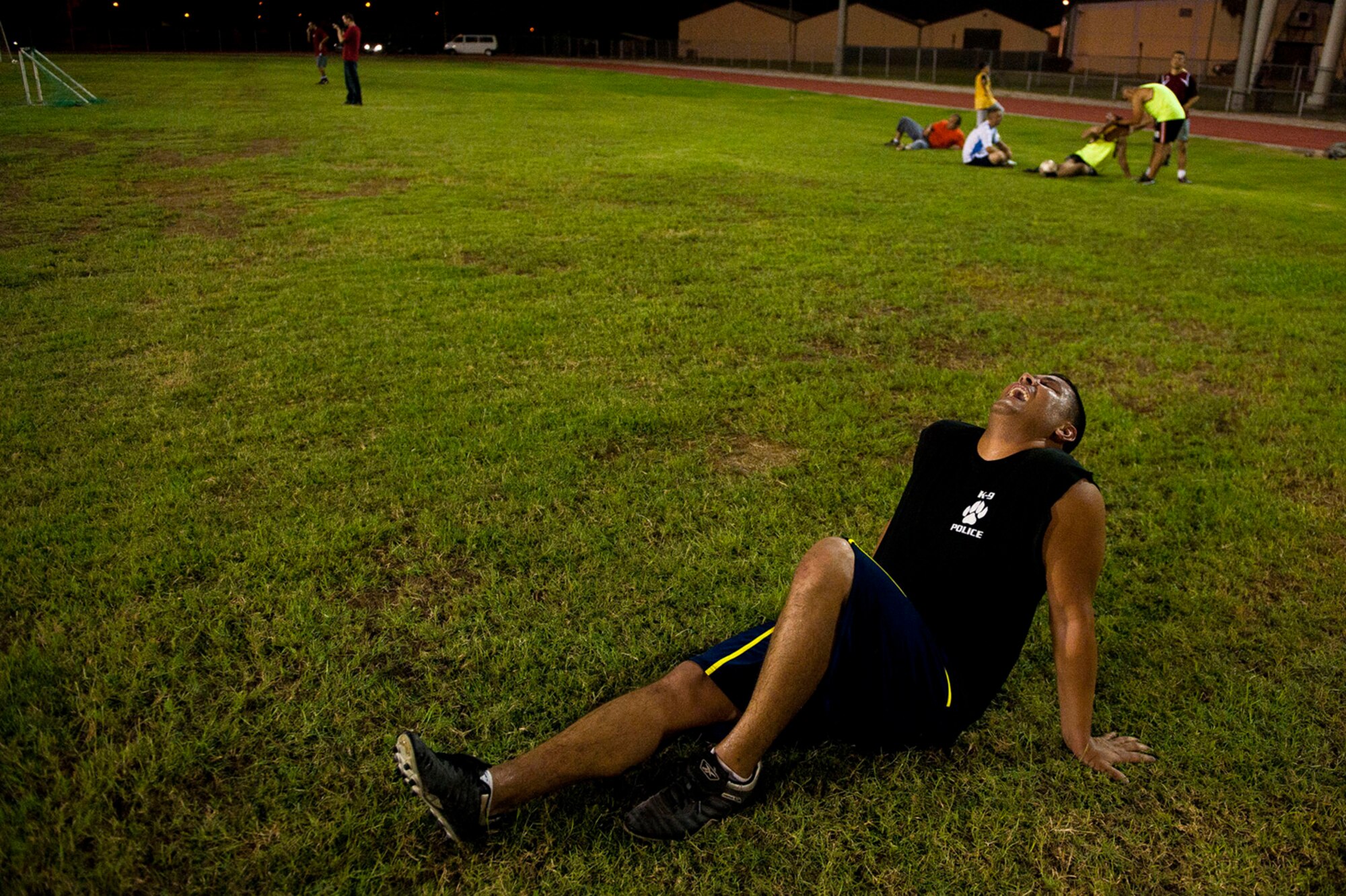 Frederick Thiessen, 39th Security Forces Squadron, yells in pain during the Late Night Soccer tournament at the high school soccer field July 29, 2011, at Incirlik Air Base, Turkey. The Security Forces team was eliminated in the first round of the double-elimination tournament. (U.S. Air Force photo by Tech. Sgt. Michael B. Keller/Released)