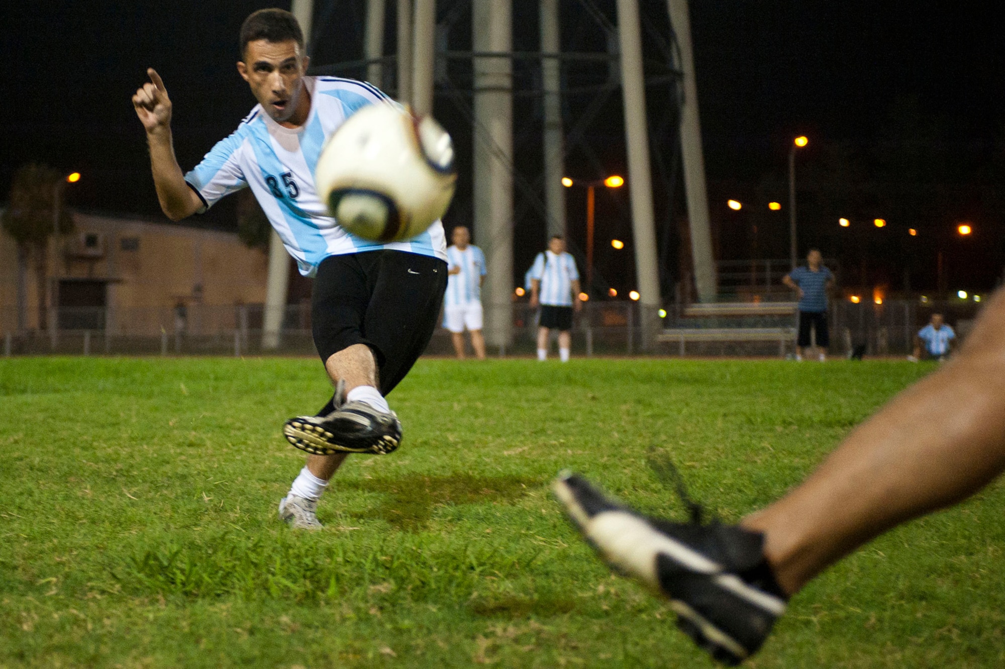 Turkish air force Ender Cemrek, a Security One team player, takes a shot at the goal during the Late Night Soccer Tournament at the high school soccer field July 29, 2011, at Incirlik Air Base, Turkey. Security One defeated the Turkish Stars in the double-elimination tournament. (U.S. Air Force photo by Master Sgt. James Law/Released)