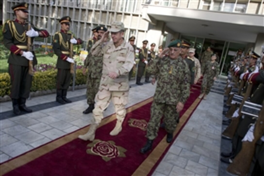 U.S. Navy Adm. Mike Mullen, chairman of the Joint Chiefs of Staff, and Lt. Gen. Sher Mohammad Karimi, chief of the General Staff of the Afghan National Army, depart the Ministry of Defense in Kabul, Afghanistan, July 31, 2011. Mullen is on a five-day USO tour with comedian Jon Stewart, NBA legend Karl Malone and magician David Blaine visiting troops in Afghanistan and Iraq.