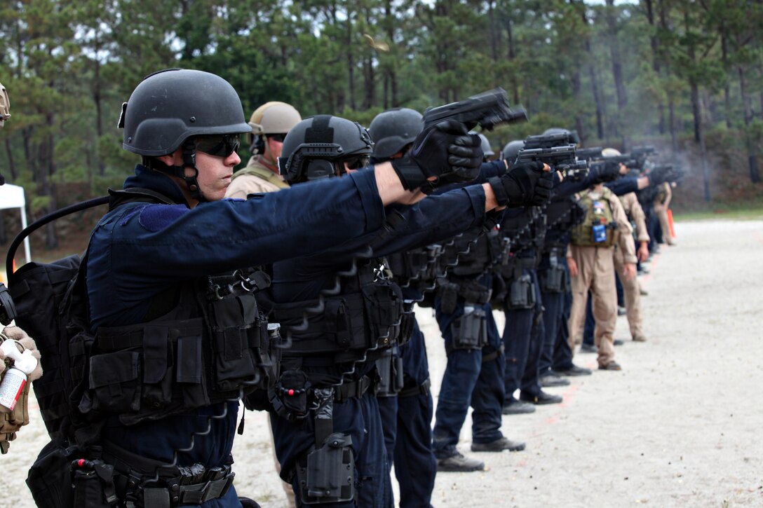 Students of the Basic Tactical Operations Course at the Joint Maritime Training Center aboard Marine Corps Base Camp Lejeune fire Sig Sauer P229s at the range, June 1.  The seven-week class provides the basics of marksmanship to Coast Guardsmen within the Deployable Specialized Forces community.