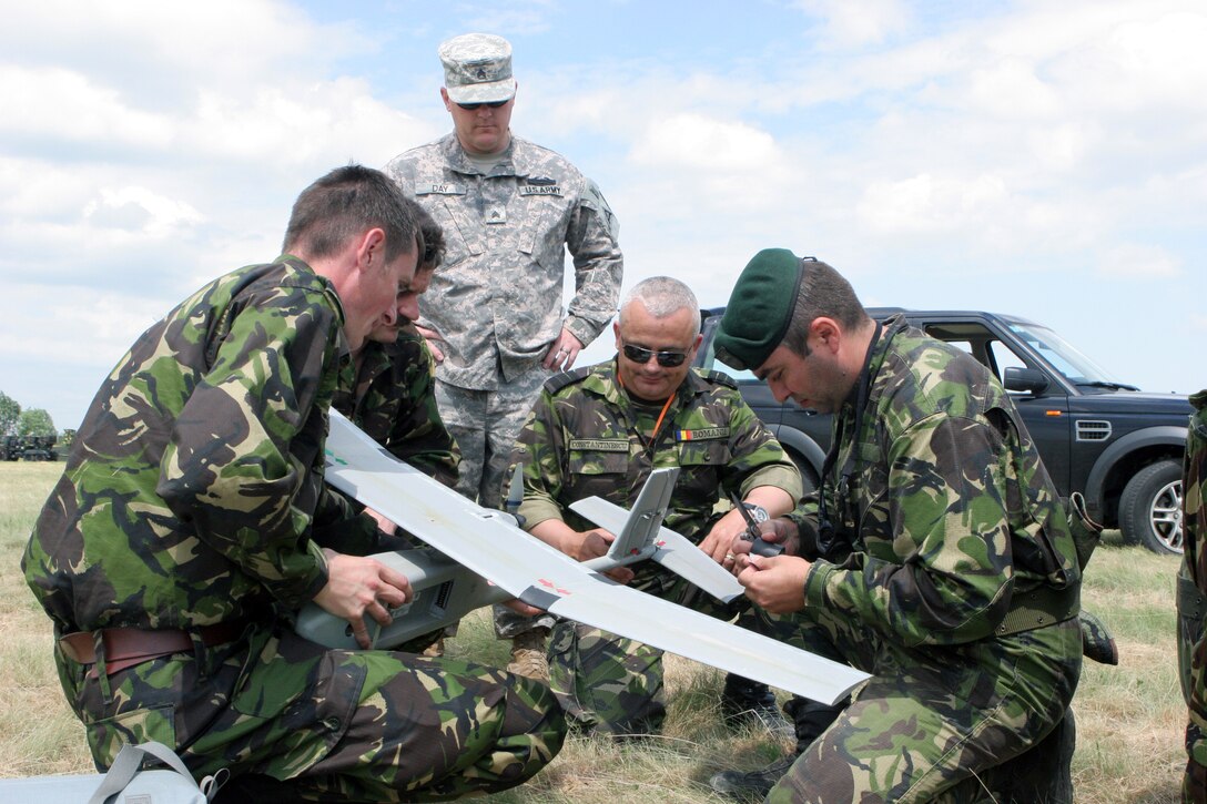 Army Sgt. Marshall Day, infantryman/Raven-B operator, observes Romanian soldiers assemble the Raven, unmanned aerial vehicle after a flight. Day is supporting Black Sea Rotational Force 11 along with SSgt. Stephen Provence. These soldiers bring real-life deployment experience with the Raven system to help the Romanian army familiarize themselves with man-packable UAV technology.