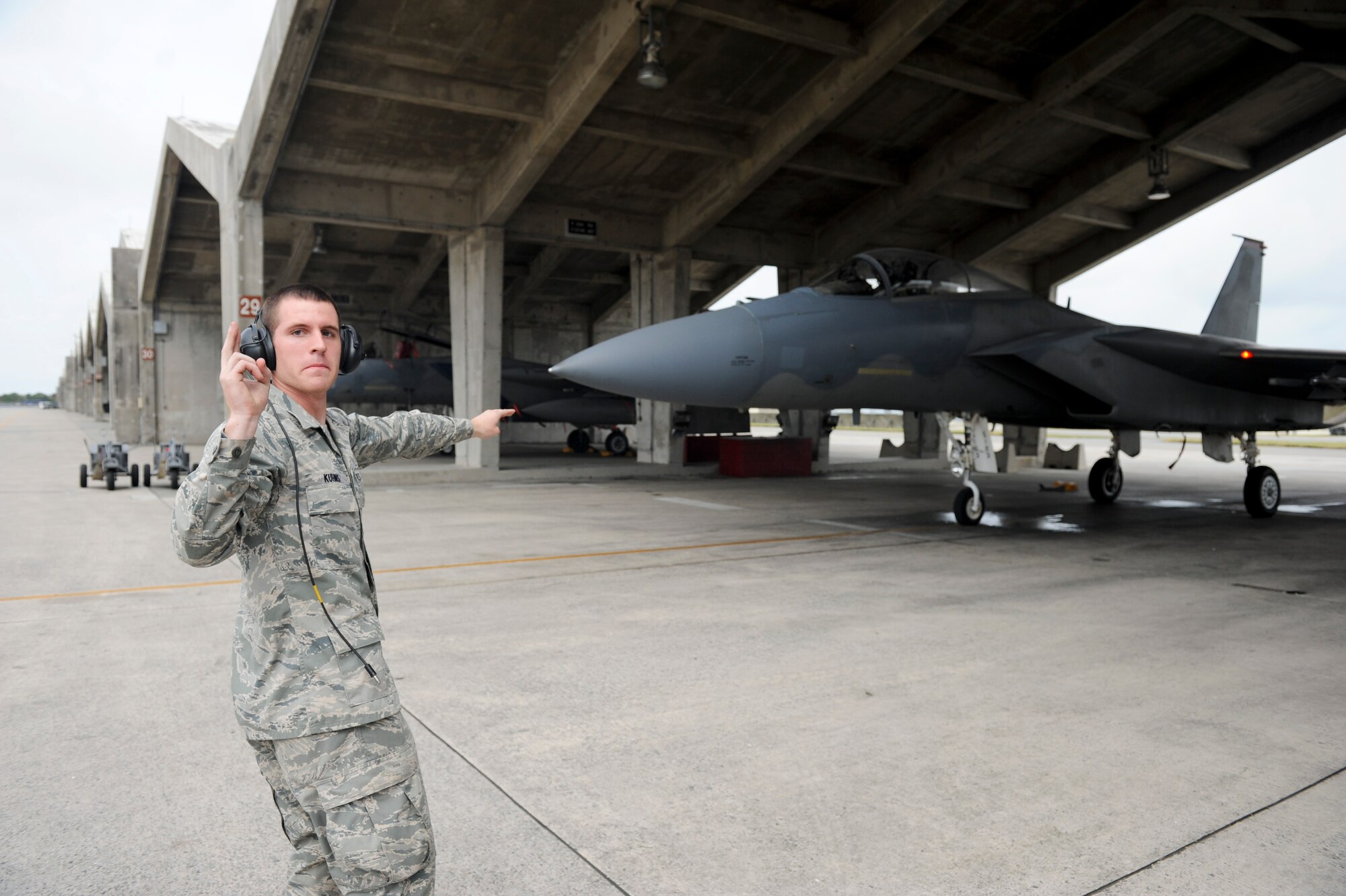 Airman 1st Class Cody Kuhs, 67th Aircraft Maintenance Unit, marshals Brig. Gen. Ken Wilsbach, 18th Wing commander, in an F-15 Eagle for his final flight as the wing commander June 1. Following a change of command ceremony June 3, General Wilsbach will leave Kadena to become the United States Pacific Command deputy director for operations.(U.S. Air Force photo/Staff Sgt. Jonathan Steffen)
