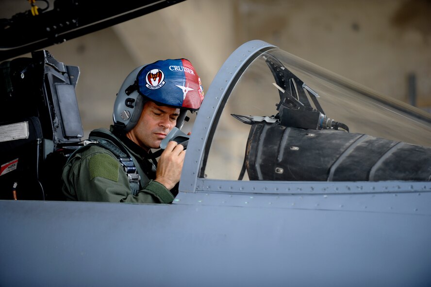 Brig. Gen. Ken Wilsbach, 18th Wing commander, puts on his face mask while sitting in an F-15 Eagle prior to his final flight as the wing commander June 1. Following a change of command ceremony June 3, General Wilsbach will leave Kadena to become the United States Pacific Command deputy director for operations . (U.S. Air Force photo/Staff Sgt. Jonathan Steffen)