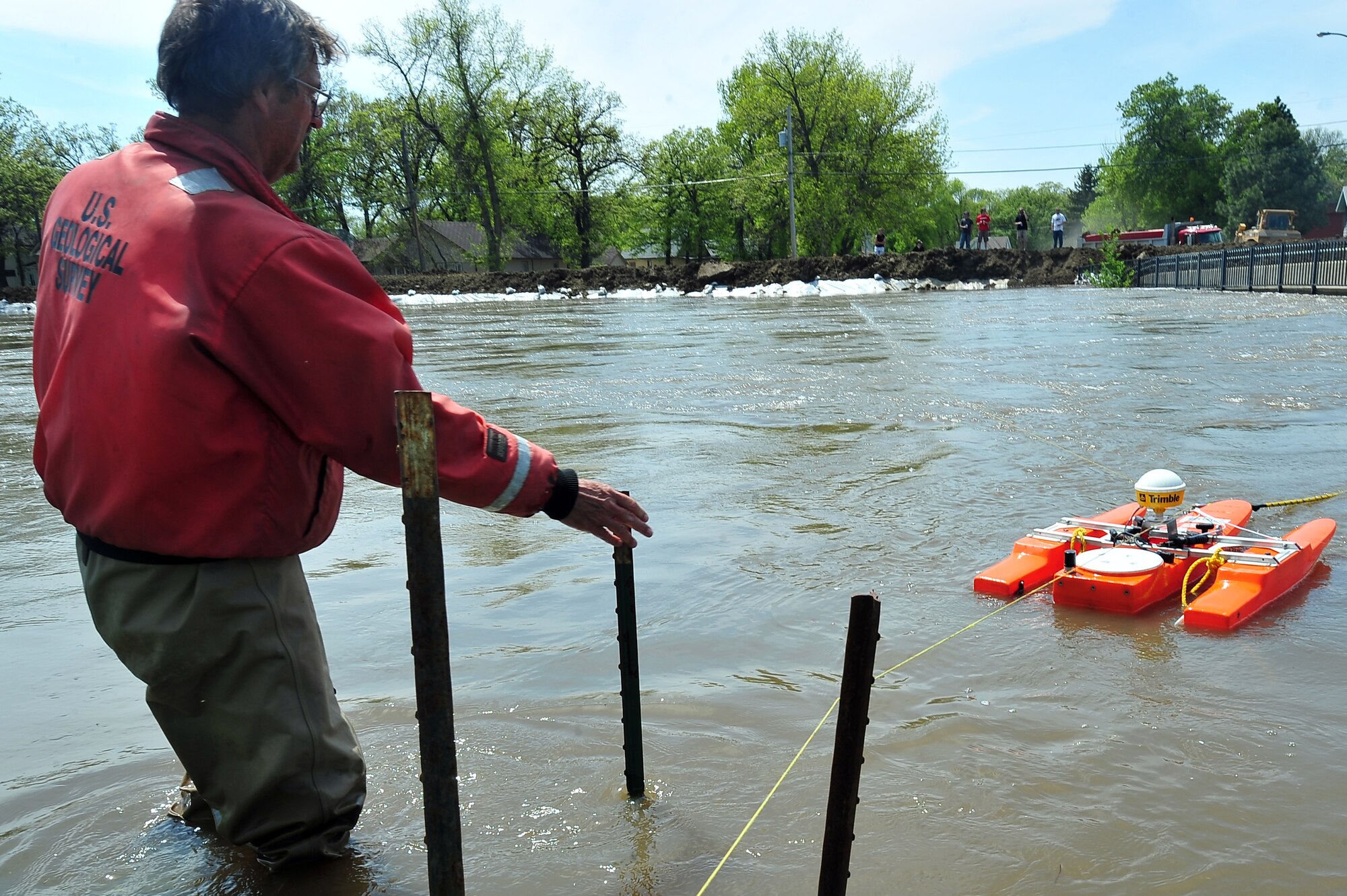Larry Rutschke, a hydrological technician with the U.S. Geological Survey, measures the flow of the Souris River June 1, 2011, in Minot, N.D.  In preparation for possible flooding, Airmen from nearby Minot Air Force Base and members of the North Dakota National Guard as well as volunteers from many other organizations, are setting up secondary dikes along the river.  The Souris threatens to break the levies already in place, forcing thousands of Minot citizens, including Airmen, their families and DOD civilians, to evacuate the area. (U.S. Air Force photo/Senior Airman Jesse Lopez)