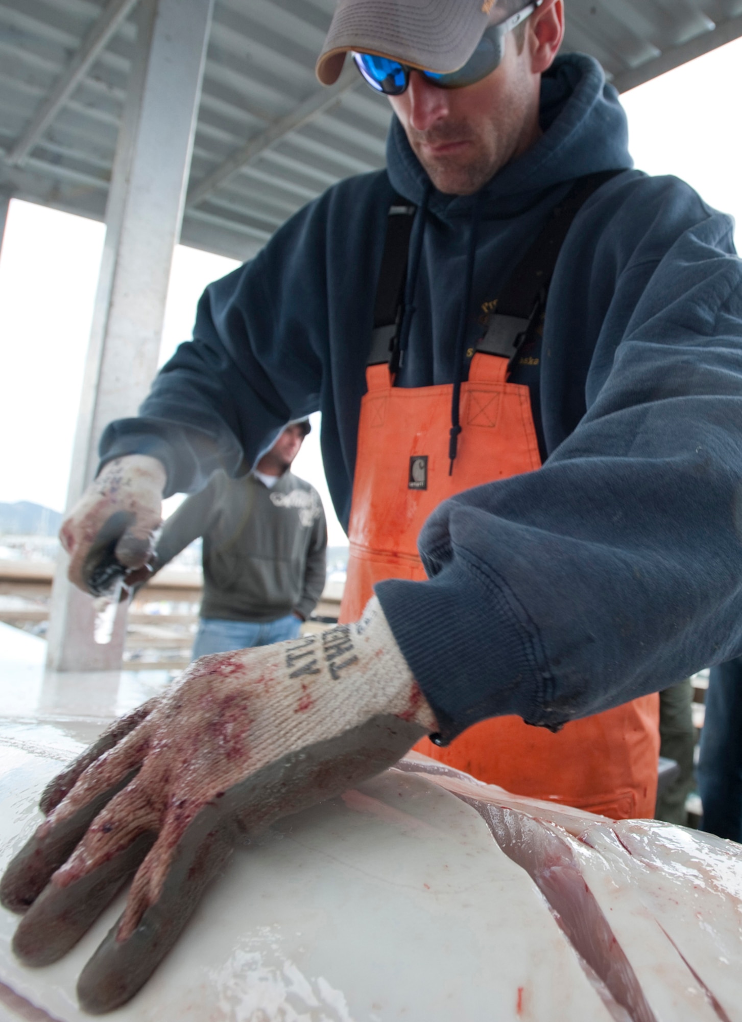 SEWARD, Alaska ? Nick Meadows, one of the many deckhands for the 5th Annual Combat Fishing Tournament fillets up a halibut May 26 during. For the fifth straight year the Seward Charter Association has dedicated a day to taking out military members serving in Alaska to a day of fishing. This year approximately 275 veterans participated in the tournament. (U.S. Air Force photo/Senior Airman Christopher Gross)