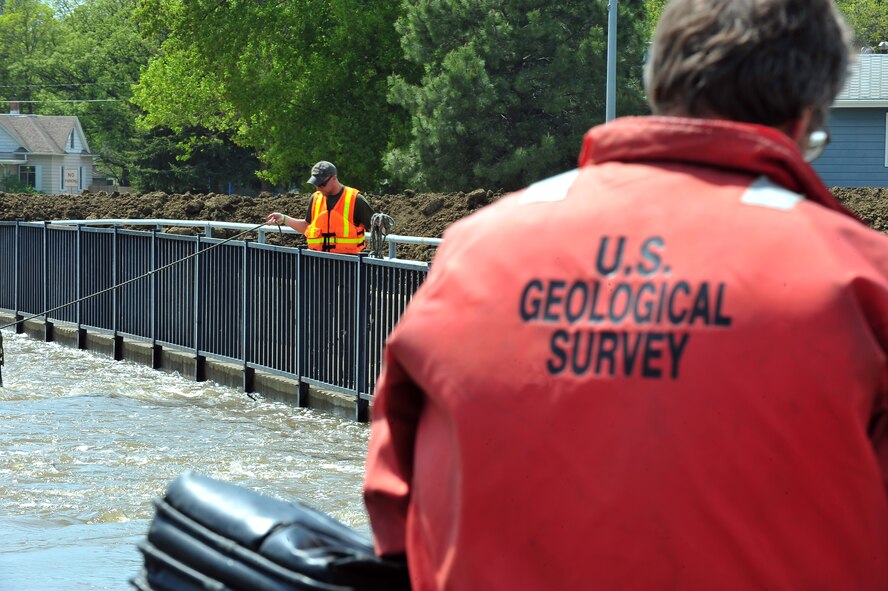 MINOT, N.D. – Larry Rutschke and Zack Hillman, U.S. Geological Survey, hydrological technicians, measures the flow of water June 1 In preparation for possible flooding, as Airmen from Minot Air Force Base, North Dakota National Guard as well as many other organizations, are setting up secondary dikes along the river. The Souris River threatens to break the levies already in place, thousands of Minot citizens, including military members, their families and DoD civilians, have been forced to evacuate the area.  (U.S. Air Force photo/Senior Airman Jesse Lopez)