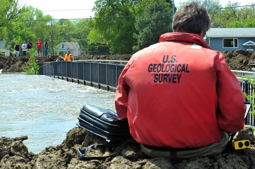MINOT, N.D. – Larry Rutschke and Zack Hillman, U.S. Geological Survey, hydrological technicians, measures the flow of water June 1 In preparation for possible flooding, as Airmen from Minot Air Force Base, North Dakota National Guard as well as many other organizations, are setting up secondary dikes along the river. The Souris River threatens to break the levies already in place, thousands of Minot citizens, including military members, their families and DoD civilians, have been forced to evacuate the area.  (U.S. Air Force photo/Senior Airman Jesse Lopez)