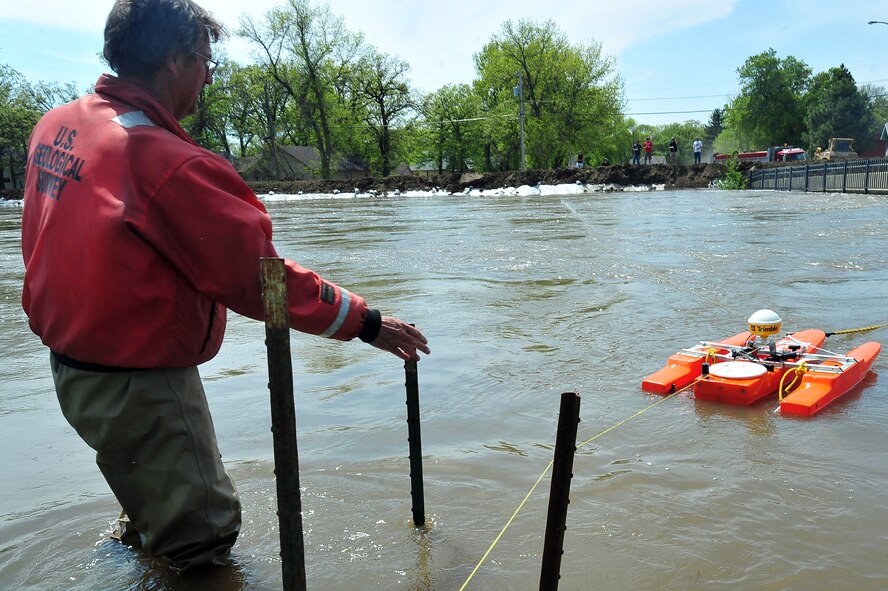 MINOT, N.D. – Larry Rutschke, U.S. Geological Survey, hydrological technician, measures the flow of water June 1 In preparation for possible flooding, as Airmen from Minot Air Force Base, North Dakota National Guard as well as many other organizations, are setting up secondary dikes along the river. The Souris River threatens to break the levies already in place, thousands of Minot citizens, including military members, their families and DoD civilians, have been forced to evacuate the area.  (U.S. Air Force photo/Senior Airman Jesse Lopez)